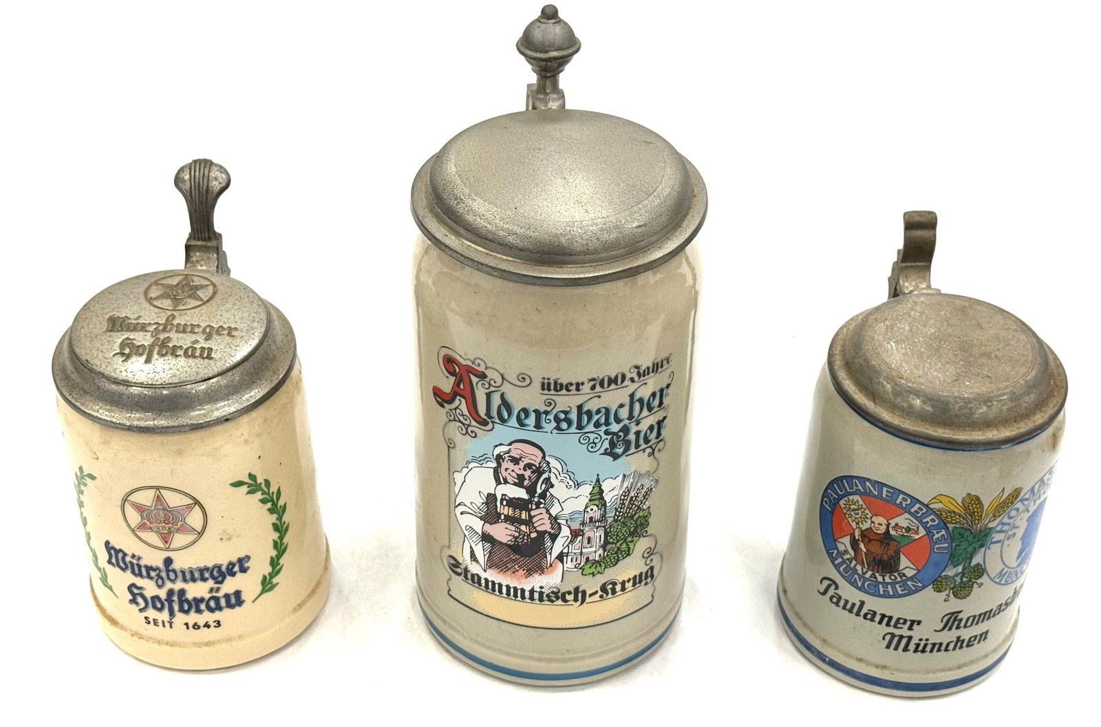 (3) German Brewery Advertisement Steins: (3) German Brewery Advertisement Steins. Each Of These Steins Are In Good, Used Condition. They Depict Murzburger Hofbrau, Aldersbacher Bier, Paulanerbraeu and ThomasBraeu Beer Of Munich. There Are No