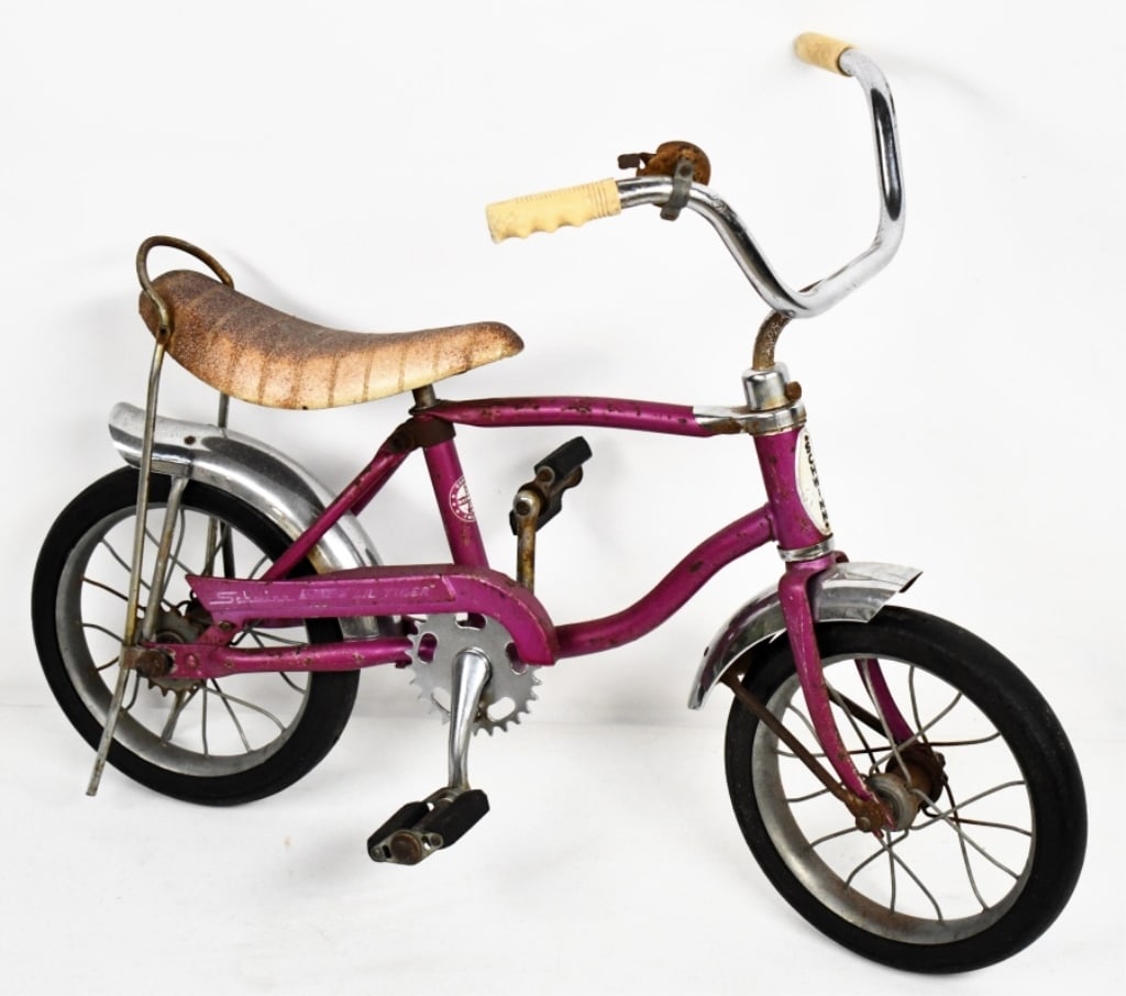 Vintage Schwinn Lil Tiger Sting-Ray Bicycle: Vintage Schwinn Lil Tiger Sting-Ray Bicycle. The bike features banana seat, and Schwinn handlebar grips. It is missing the chain, surface rust, paint loss, and wear from use and age. Serial number ill