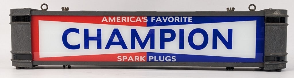 Vintage Champion Spark Plugs Lighted Sign: Vintage Champion Spark Plugs lighted advertising sign. The light works great and the lens is new. The condition is nice with age and display wear to the vintage metal can. Measures approximately 5-1/2