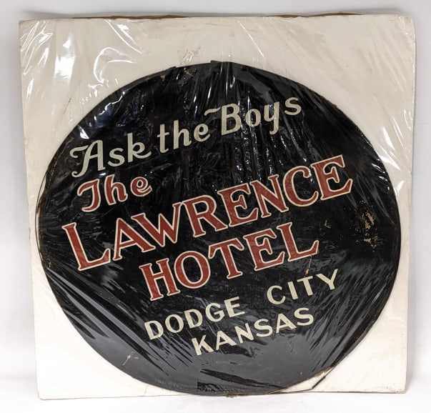 Vintage The Lawrence Hotel Advertising Tire Cover: Vintage painted canvas "Ask The Boys The Lawrence Hotel Dodge City Kansas" spare tire cover advertising sign. The cover is in good condition with some age and use wear, displays great. Measures approx