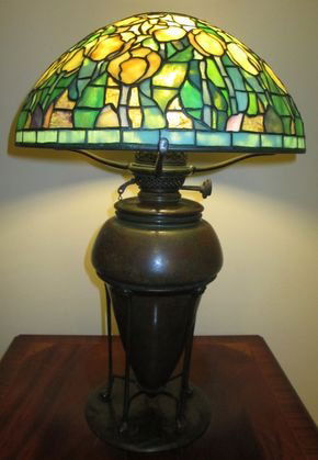 Tiffany Studios Leaded Glass Lamp Tulip Pattern: For sale is a Tiffany Studios Leaded Glass lamp commonly referred to as Sunset Tulip. This is a rare sized lamp with various stages of tulip blooms from buds to full florals. Shade is supported by a t