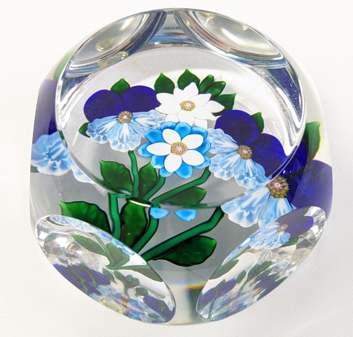 Vintage St. Louis Glass Floral Paperweight: Vintage St. Louis Glass Floral Faceted Paperweight. The paperweight features pansies and other flowers. It is in great condition and measures approximately 2" tall x 2-3/4" in diameter.