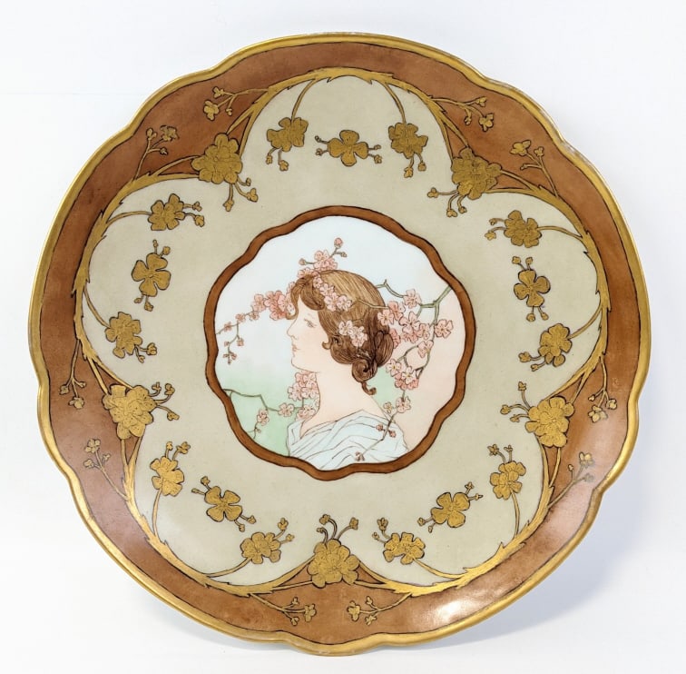 Art Nouveau Limoges Hand-Painted Porcelain Charger: Nice Art Nouveau Limoges hand-painted porcelain charger. The charger features a young woman in the center with brown and gold decoration. Signed Selby and dated 1908 on the reverse. Nice condition and