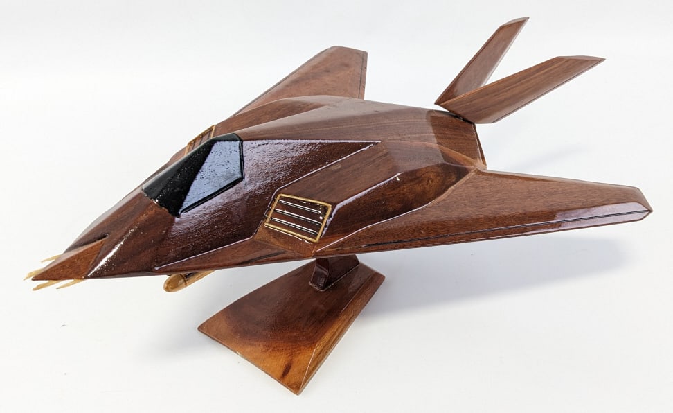 USAF F-117 Blackhawk Mahogany Desktop Airplane: USAF F-117 Blackhawk Mahogany Desktop Airplane. The plane comes on a stand and displays great. Measures 7-1/2" tall x 18" across with a 12" wingspan.