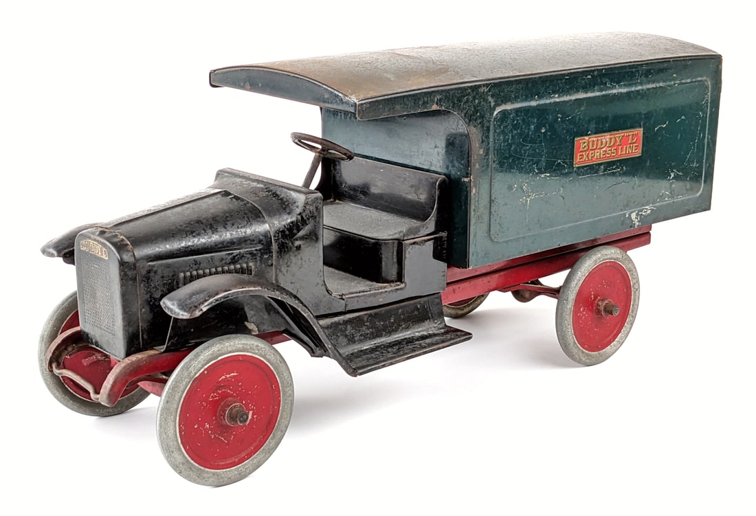 Buddy L Express Line Truck: Buddy L Express Line truck. The rear doors on the truck have been replaced and appropriately aged to look original. The truck has some old overpaint on the black cab, shows patina, and age wear throug