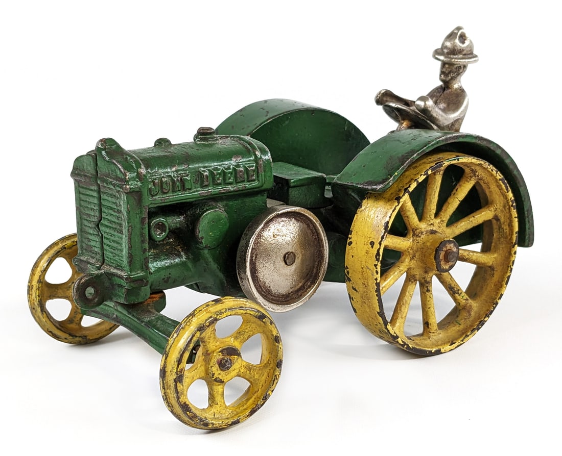 Vindex Cast Iron John Deere Model D Tractor: Vindex cast iron John Deere Model D tractor. The tractor has some older overpaint, paint chips, and wear from age. Still a hard to find Vindex cast iron toy in any condition. Measures approximately 6-