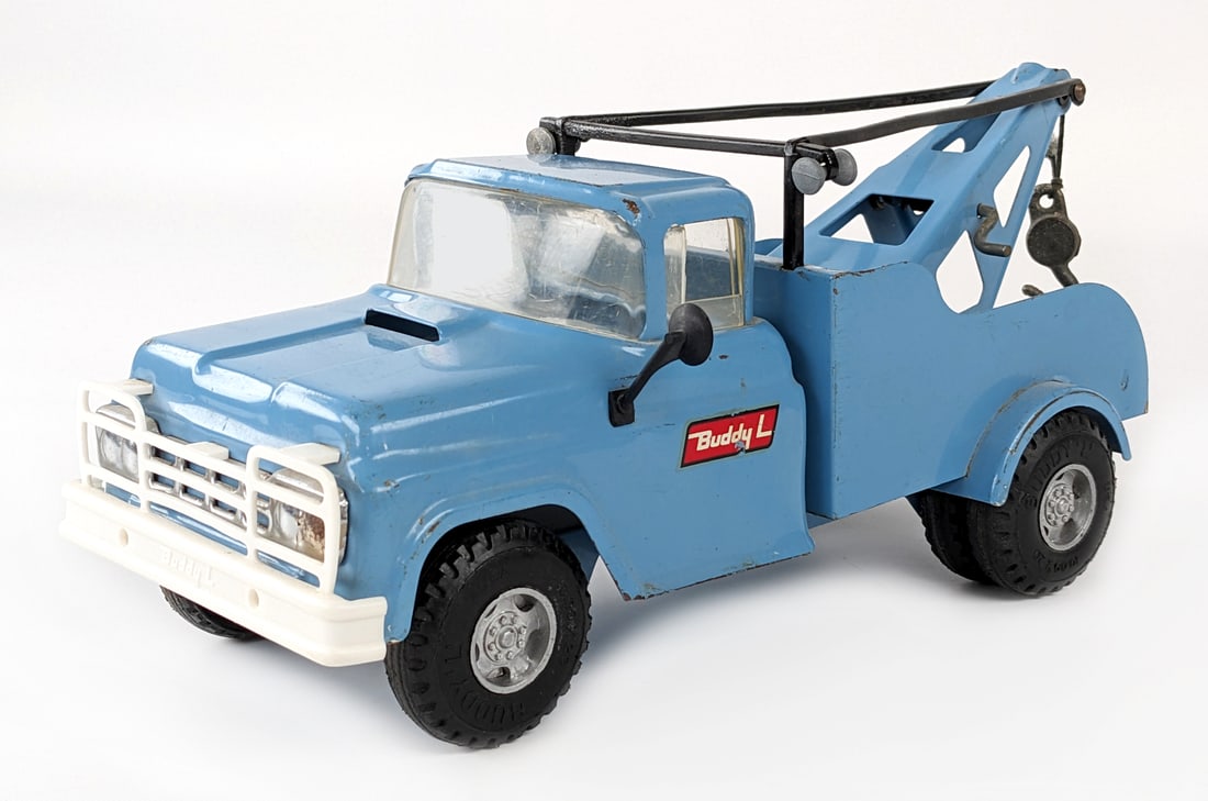 Original Buddy L Wrecker Tow Truck: Original Buddy L dual wheeled wrecker tow truck. The truck has some edge wear and minor paint loss. Measures approximately 14" long.