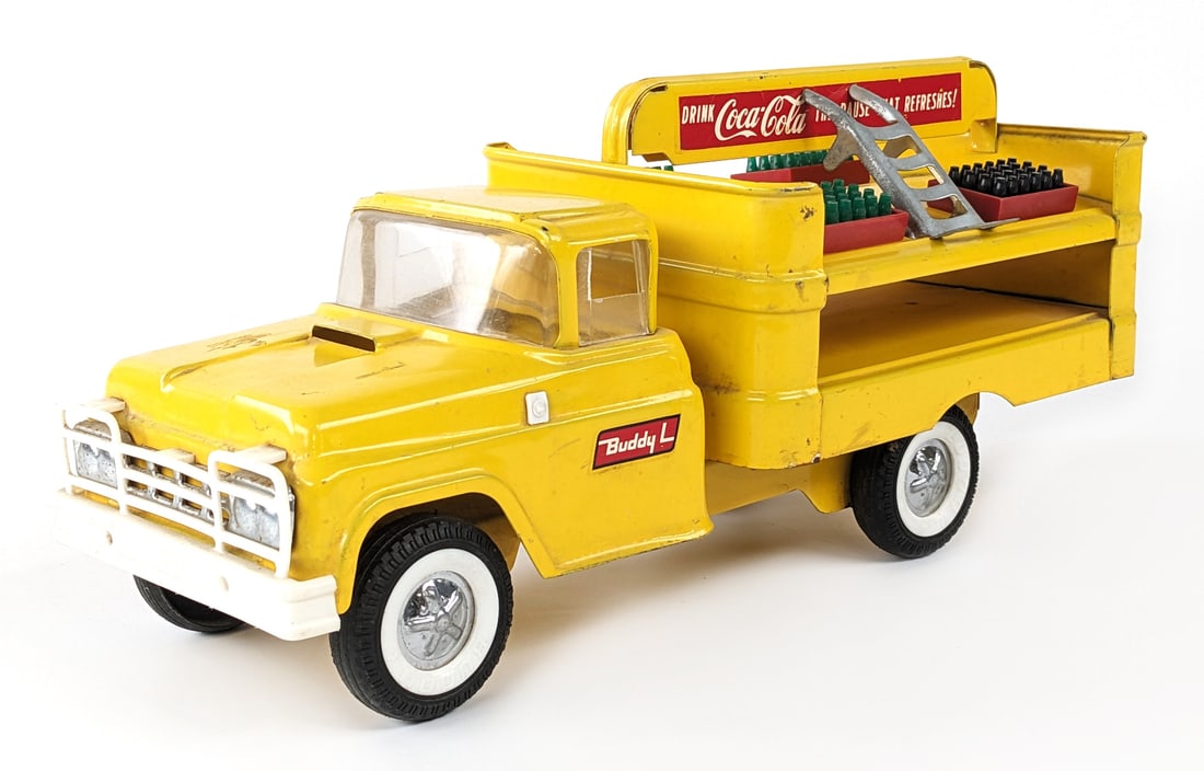 Original Buddy L Coca-Cola Delivery Truck: Original Buddy L Coca-Cola delivery truck. The truck is missing the mirror, has some scratches, and scuff marks from age / play. It comes with four crates and metal dolly. Measures approximately 15" l