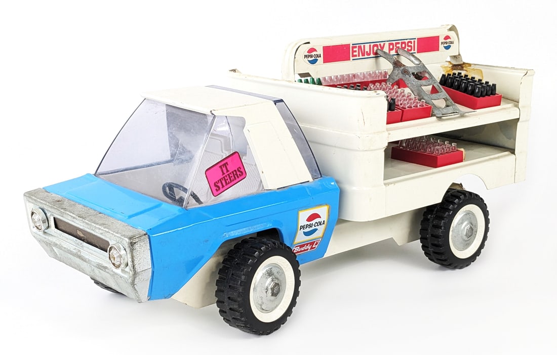 Original Buddy L Pepsi-Cola Delivery Truck: Original Buddy L Pepsi-Cola futuristic delivery truck. The truck has a small crack on the driver side part of the windshield. When you tilt the truck cab all of the wheels steer. The top advertising p