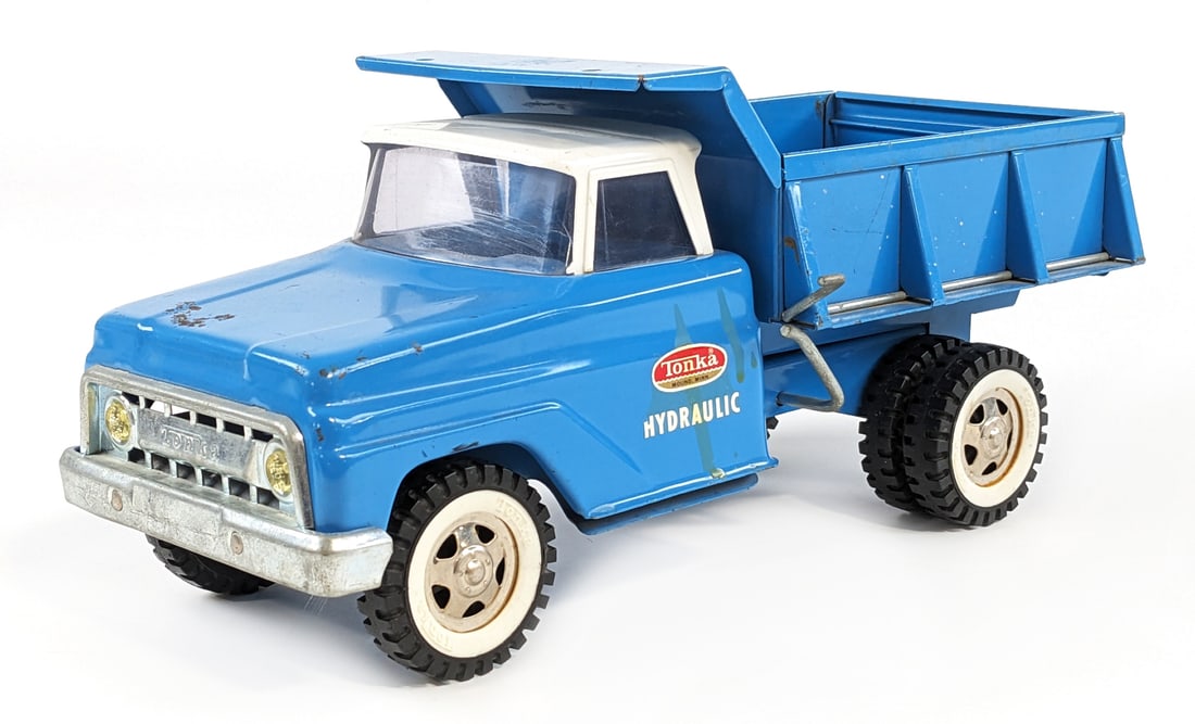 Original Tonka Hydraulic Dump Truck: Original Tonka hydraulic dump truck. The truck has some surface rust, paint loss, and wear from age. The hydraulic dump works. Measures approximately 13" long.