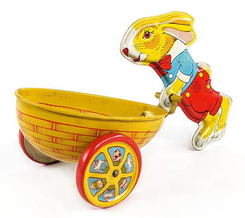 J. Chein Tin Litho Bunny With Cart: J. Chein tin litho bunny with basket / cart. The toy has some minor edge wear from age. Displays well with great color and graphics. Measures approximately 8" long.