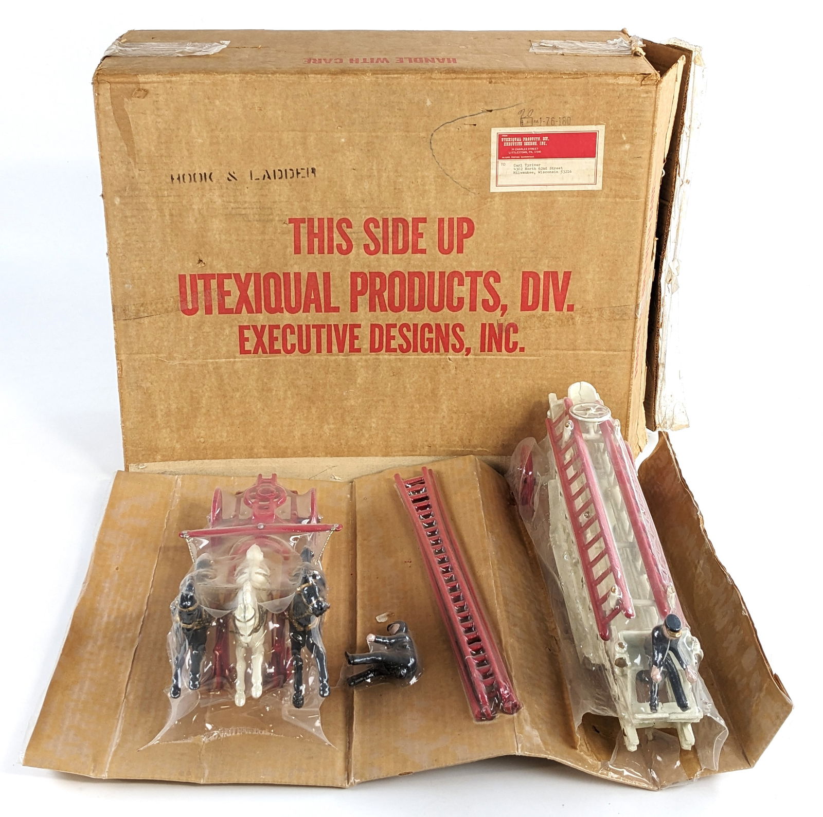 Contemporary Horse Drawn Hook & Ladder In Box: Contemporary horse drawn hook and ladder truck in the original box. The set comes new sealed in the original plastic wrap. Good condition. The box measures approximately 24" long by 20" wide by 9" tal