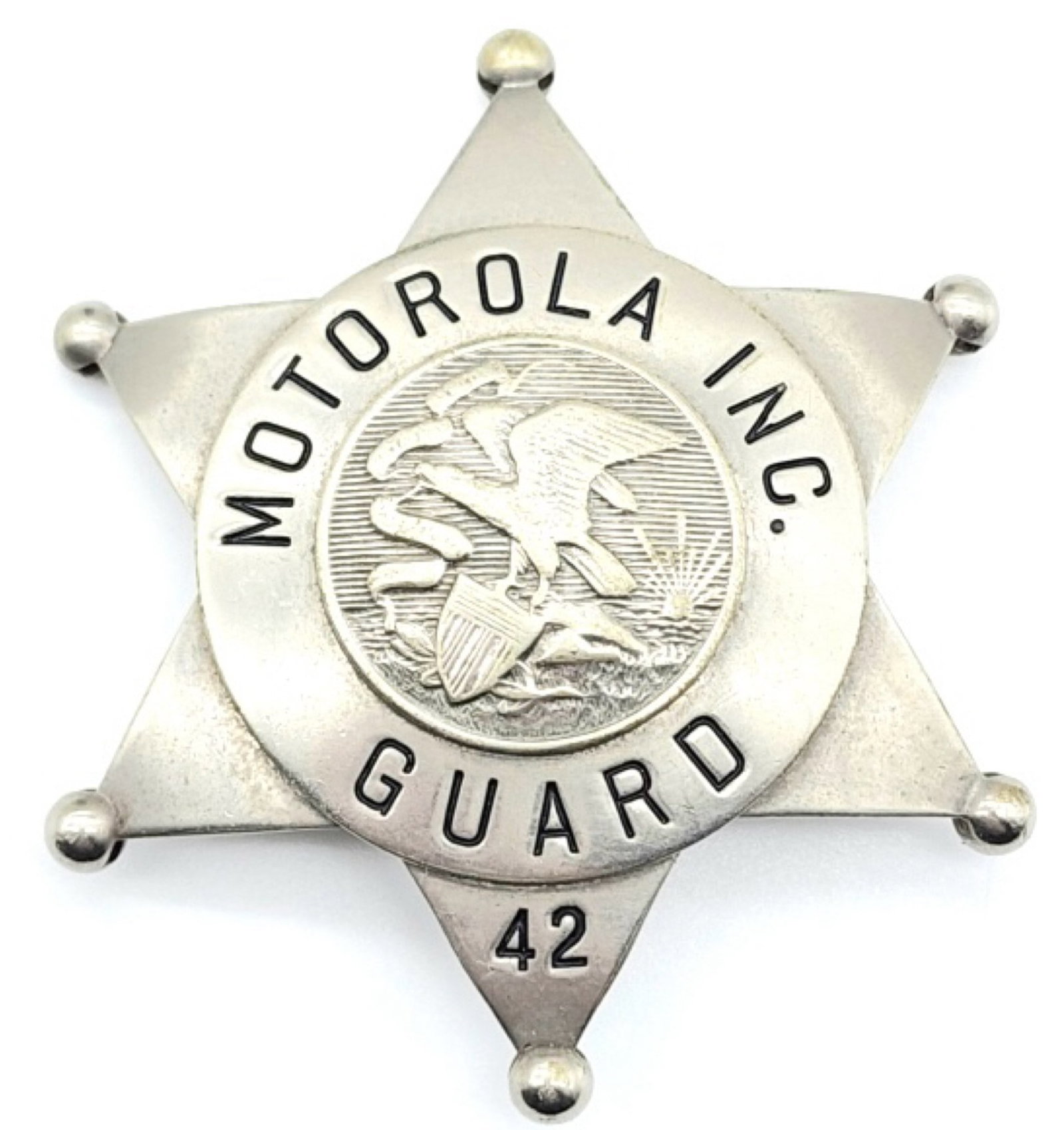 Obsolete Motorola Inc. Guard Badge #42: Obsolete Motorola Inc. Guard Badge #42. Badge is in nice condition with ball point tips and pin back, and is marked C.H. Hanson Co. Chicago. Measures 2-5/8in.