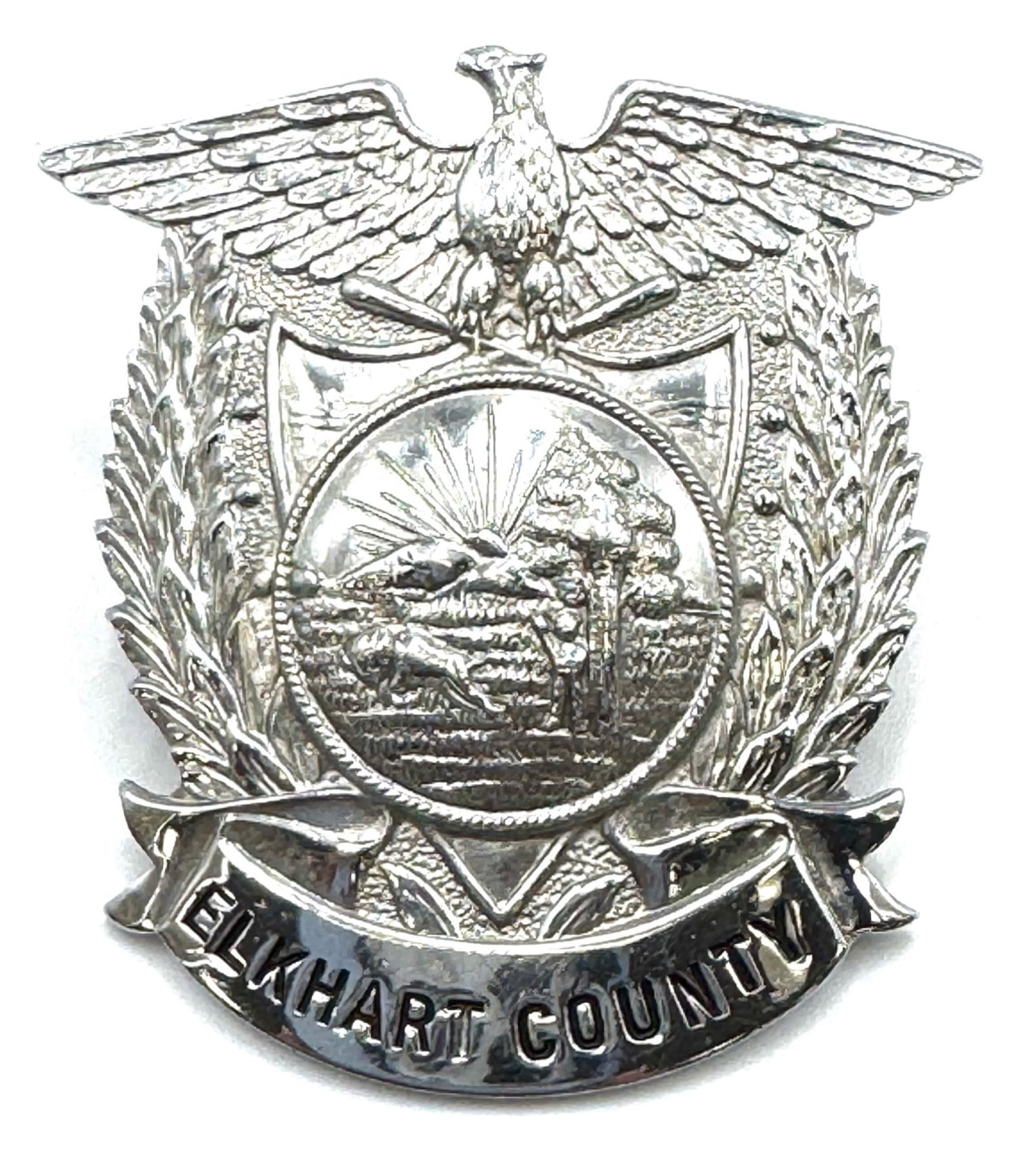 Obsolete Elkhart County Indiana Sheriff's Hat Badge: Obsolete Elkhart County Indiana Sheriff's Hat Badge.? The Elkhart County Sheriff's hat badge is in very nice used condition.? Badge measures 2 3/8 inches in length.? Badge has no makers mark.? This vi