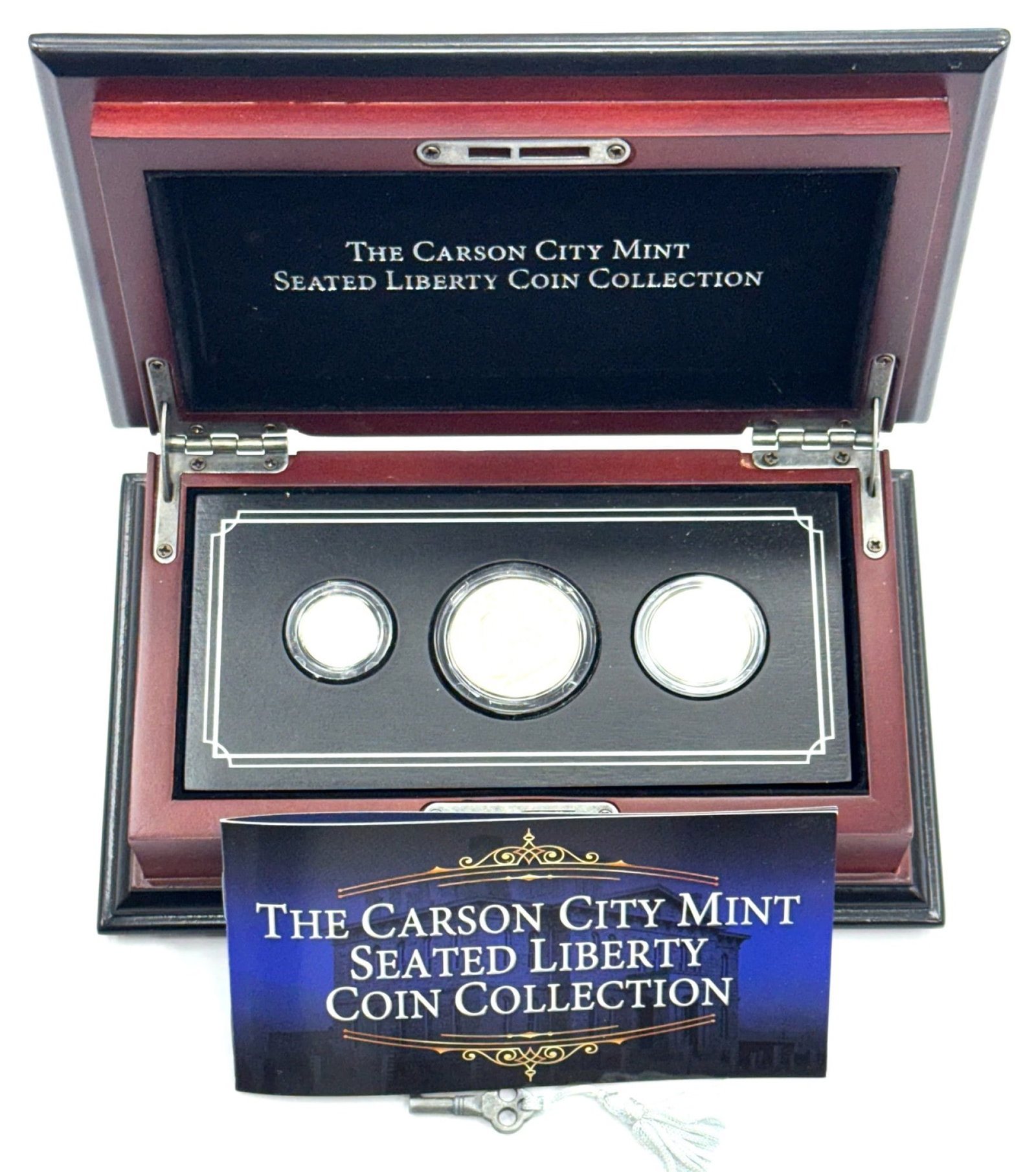 3pc The Carson City Mint Seated Liberty Coin Collection: 3pc The Carson City Mint Seated Liberty Coin Collection, this set comes in a wooden display case measuring 8in x 5in x 3in.? Set includes a 1876-CC Seated Liberty Dime, 1875-CC Seated Liberty Half Dol