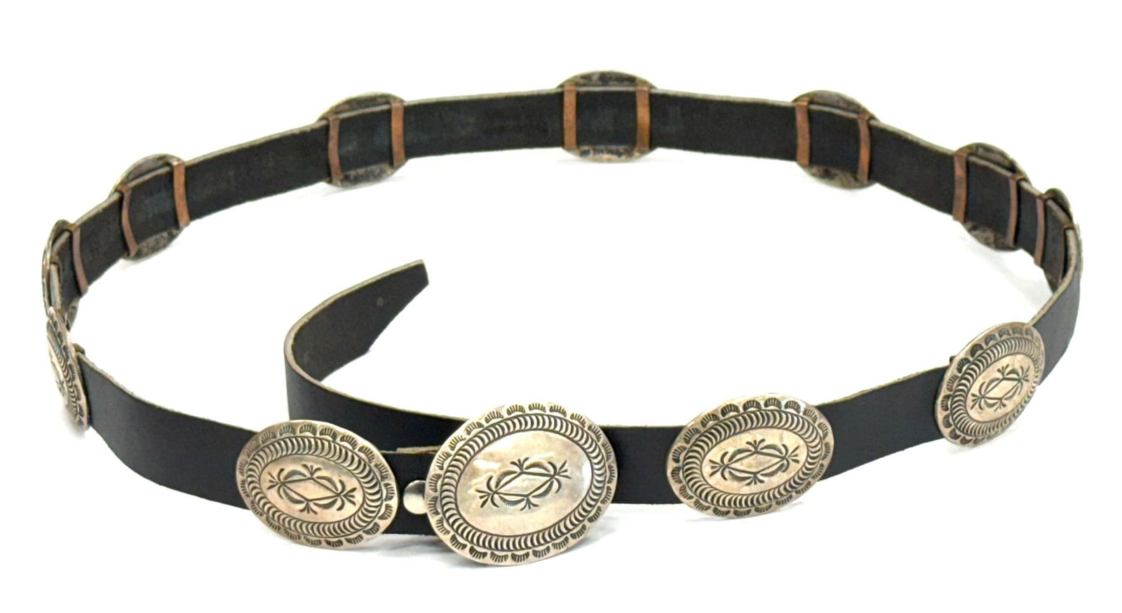 Sterling Navajo Native American Concho Belt: Sterling Navajo Native American Concho Belt. The belt features 11 engraved concho's and a slightly larger belt buckle with the same design. The concho's are attached to a leather belt and have some sc
