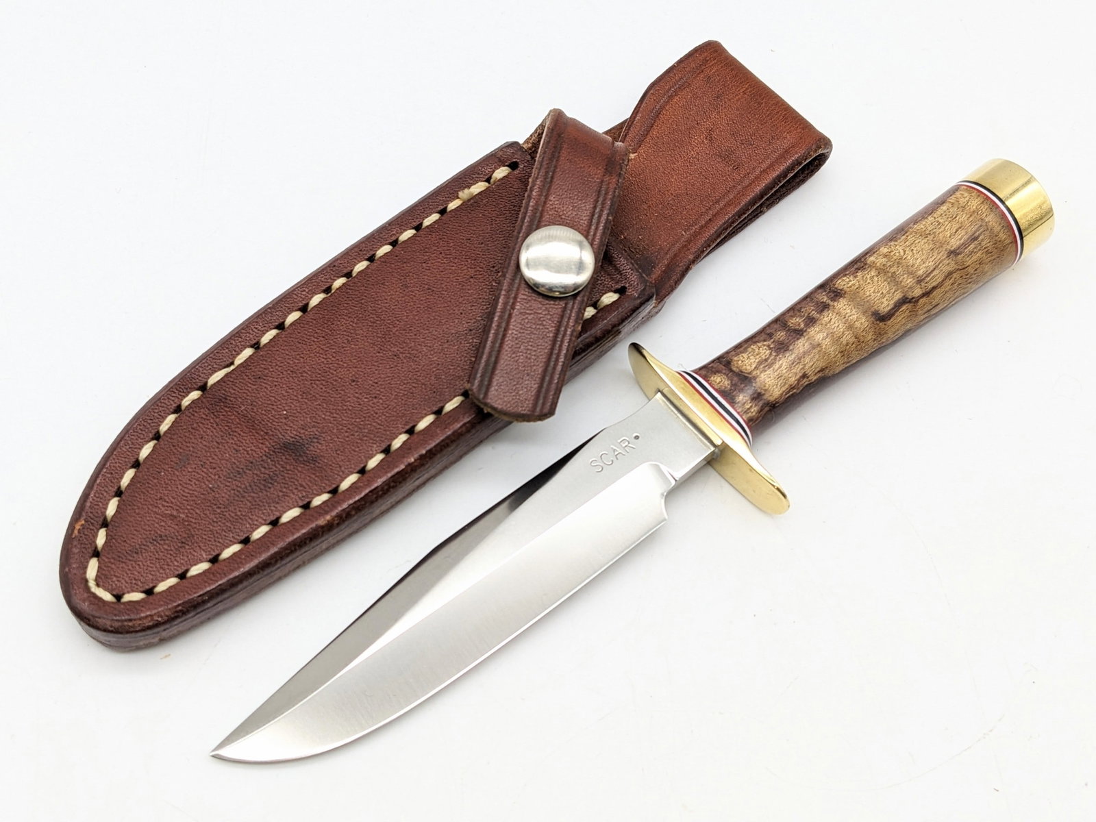 Scar Knives Randall Model 1 All Purpose Fighter Mini Reproduction Knife w/ Sheath: Knife is in new condition. Features a brass double downturned guard, and maple wood handle, brass butt cap, and nut pommel. Comes with a custom Gutcher Sullivans sheath. Blade length measures 3-3/4in 