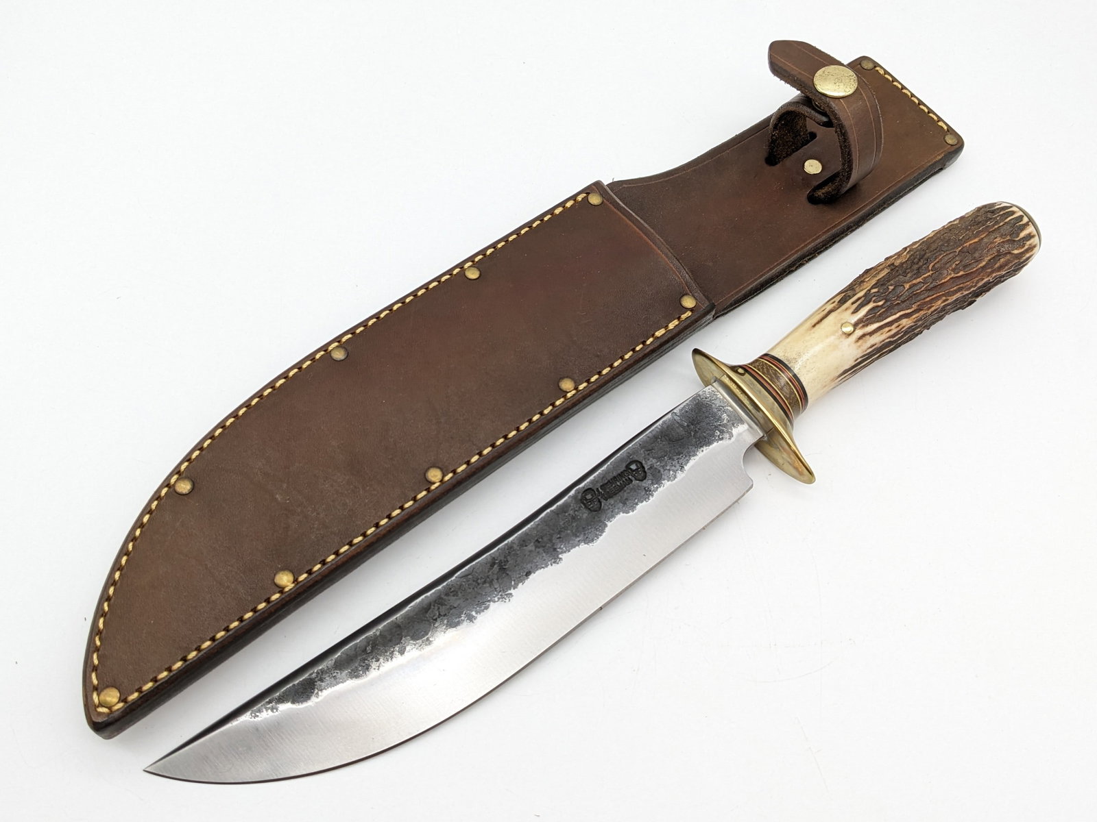 Jim Behring Treeman Double Skull Scagel Style Fighting Knife w/ Sheath: Knife is in new condition. Features a Scagel style blade with a hammer forged finish flat, Scagel style brass double guard, pinned stag handle, and brass butt cap. Comes with the custom Treeman Leathe