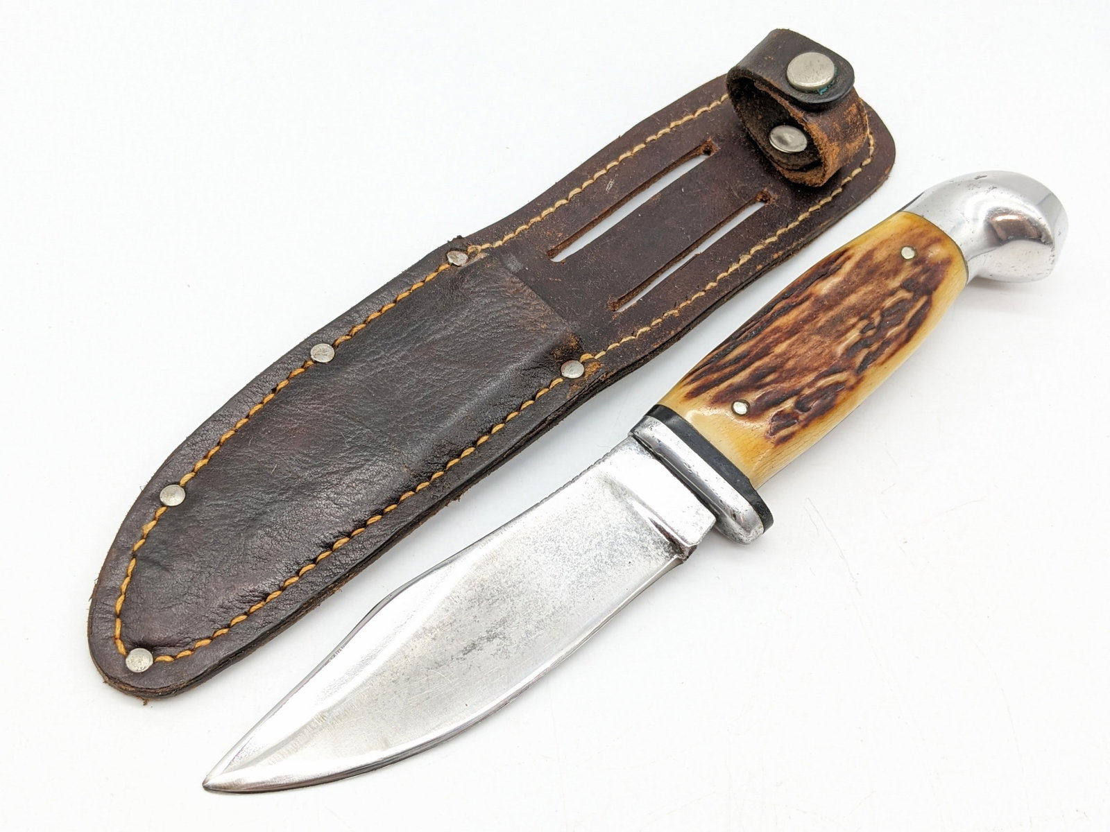 Vtg Robeson 54 Woodcraft Stag Handle Knife w/ Sheath: Knife features a Woodcrafter style blade with thumb notches and faint etched branding, aluminum guard, stag handle scales, and aluminum crows beak pommel. Knife is in used condition with grind marks f