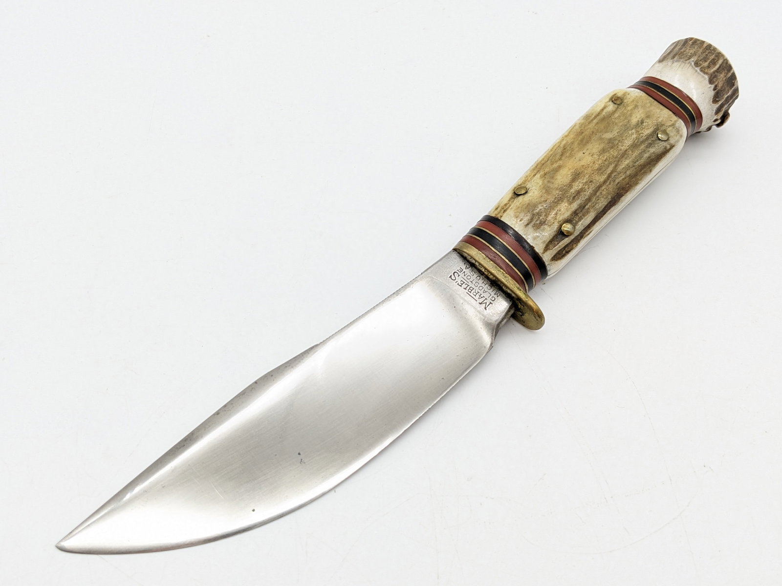 1950's Marbles Woodcraft Stag on Stag Knife: Knife features a mirror polished blade with comb back thumb notches, pinned stag handle scales with 11 spacers, and small nut stag pommel. Knife is in nice aged condition with scratches and some small