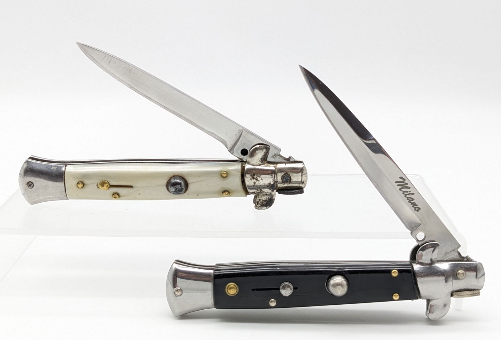 Jaguar and Milano Italian Stiletto Switchblade Knives: The Milano knife is in very nice condition with minimal wear, and the Jaguar Inox knife has material loss on the blade from use and rusting on the bolsters. Overall measures 5in when closed.