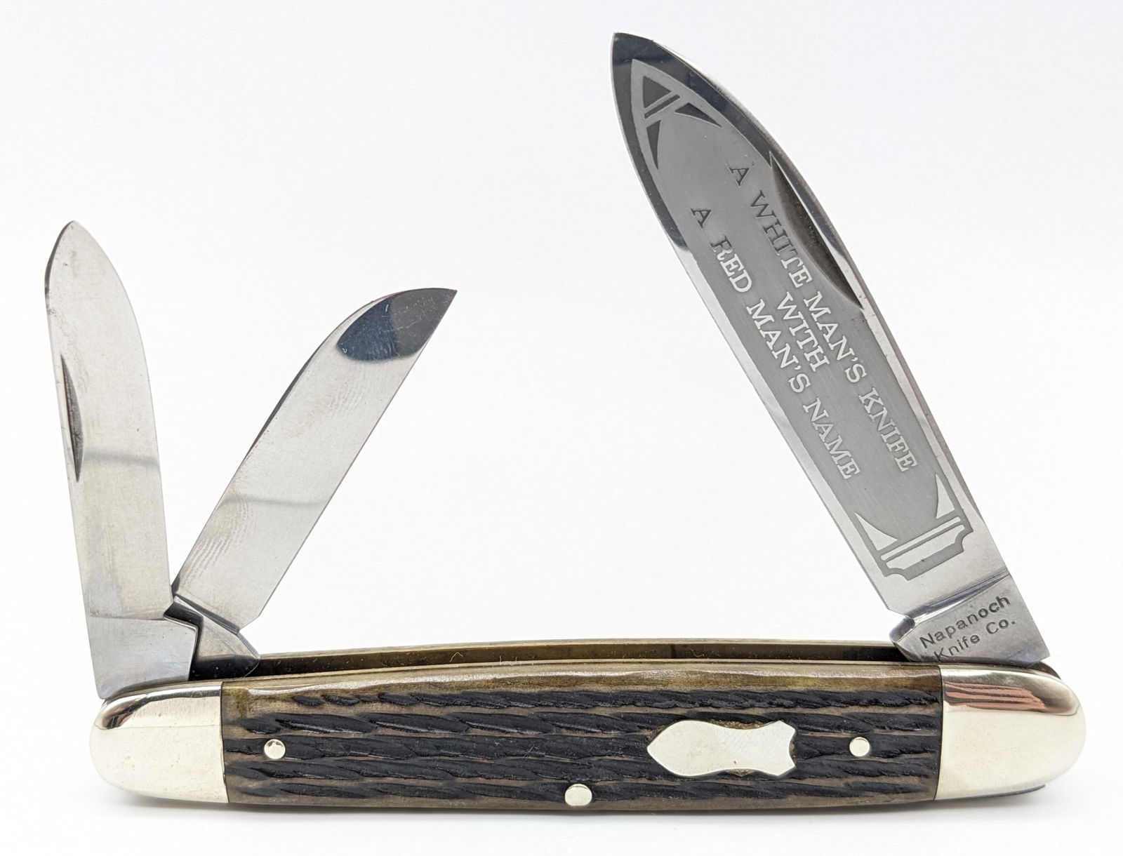 Napanich Knife Co. Jig Bone Cigar Whittler Knife: Knife is in nice condition with the phrase "A White Man's Knife With A Red Man's Name" etched on the main blade, some scuffs and tarnishing on the bolsters, and nice jig bone handle scales. Overall me