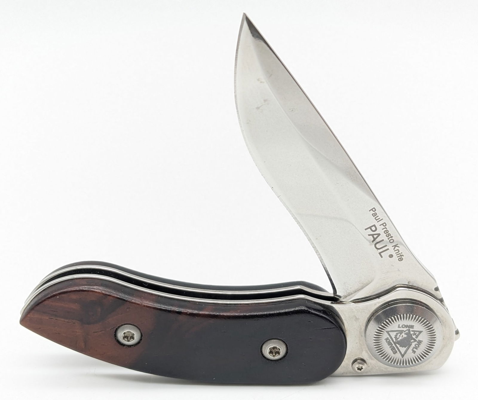 Lone Wolf Knives Paul Presto Axial Locking Folding Knife: Features the Paul Poehlmann axial locking mechanism, and snake wood handle scales. Knife is in like new condition with minimal wear from handling. Overall measures 3-1/2in when closed.