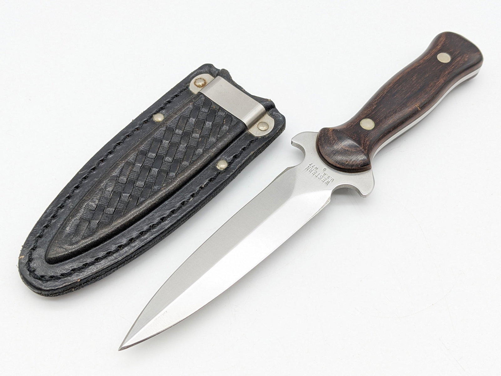 Western W77 Boot Knife w/ Sheath: Knife features a double edged blade with an integrated guard, and wooden handle scales. Blade length measures 4-1/2in and overall 8-5/8in.