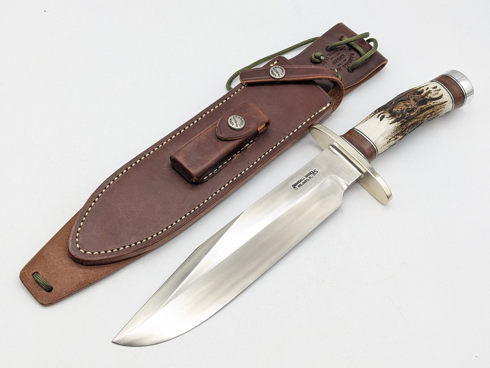 Randall Model 12 9in #14 Grind Sportsman Bowie Knife w/ Sheath: Knife is in like new condition. Features a stainless steel blade, nickel silver oblong upturned guard, stag handle with stacked leather and duralumin spacers, and duralumin butt cap. Comes with the Ra