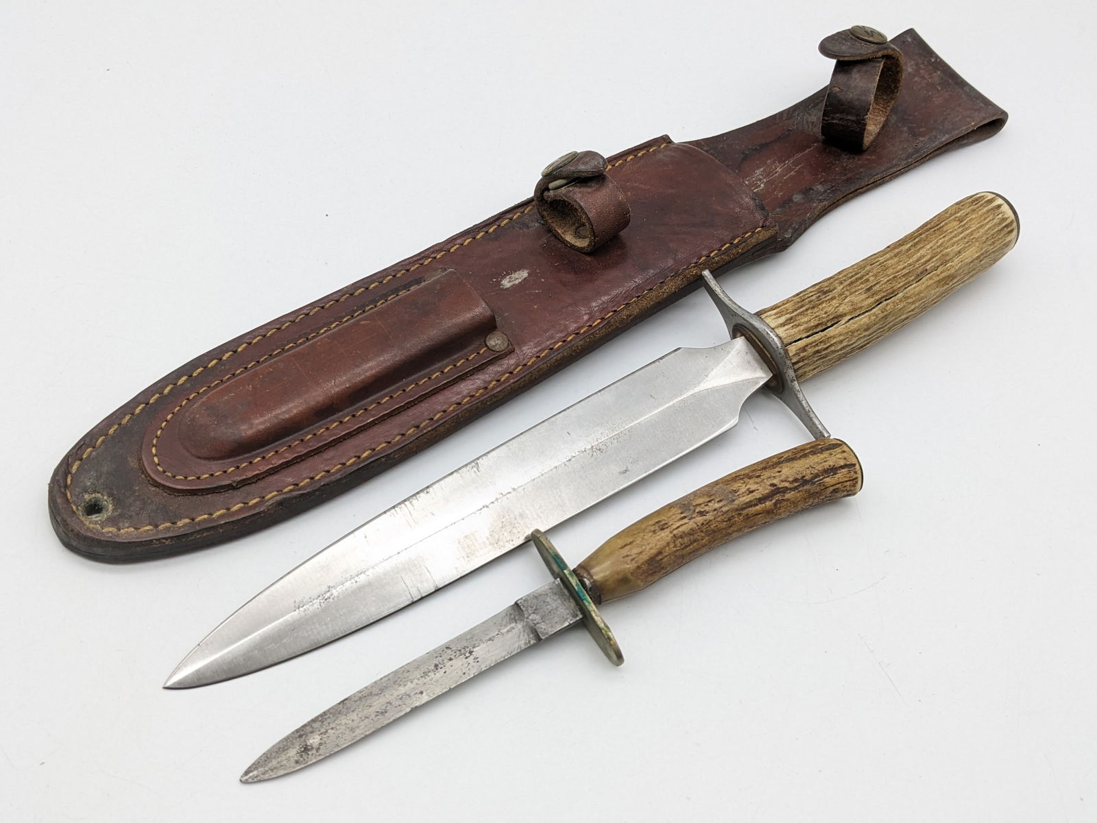 Civil War Style Stag Handle Piggy Back Dagger Set: Features an unmarked main dagger and Joseph Allen & Sons marked secondary dagger, double guards, and stag handles. The sheath is unmarked with MM stamped brass buttons. Knives are in aged condition wi