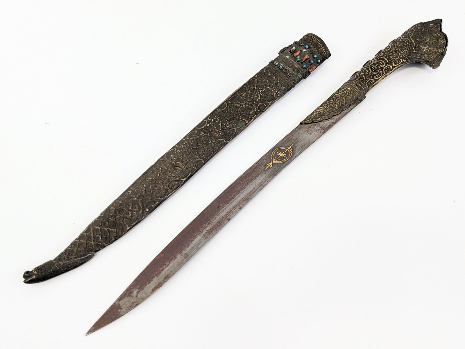 Middle Eastern Fixed Blade Ceremonial Knife w/ Scabbard: Knife features a gold inlayed design on either? side, and a hammered metal handle with natural stone inlays. The sheath is made the same way with a hammered metal exterior with more natural stone inla