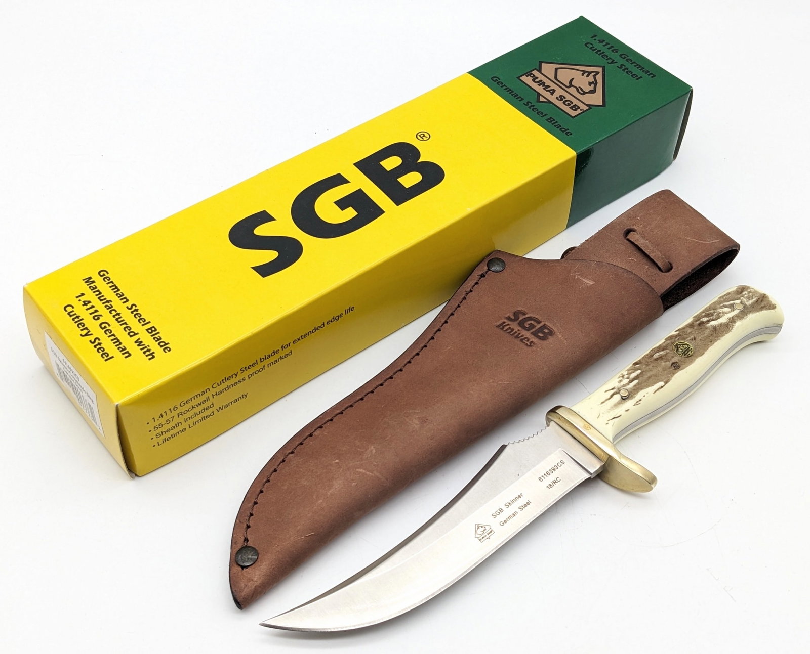 NIB Puma SGB Skinner Hunting Knife w/ Sheath: Knife features a trailing point blade with thumb notches, brass downturned guard, and stag handle. Knife is in new condition. Blade length measures 5-1/4in and overall 9-5/8in.