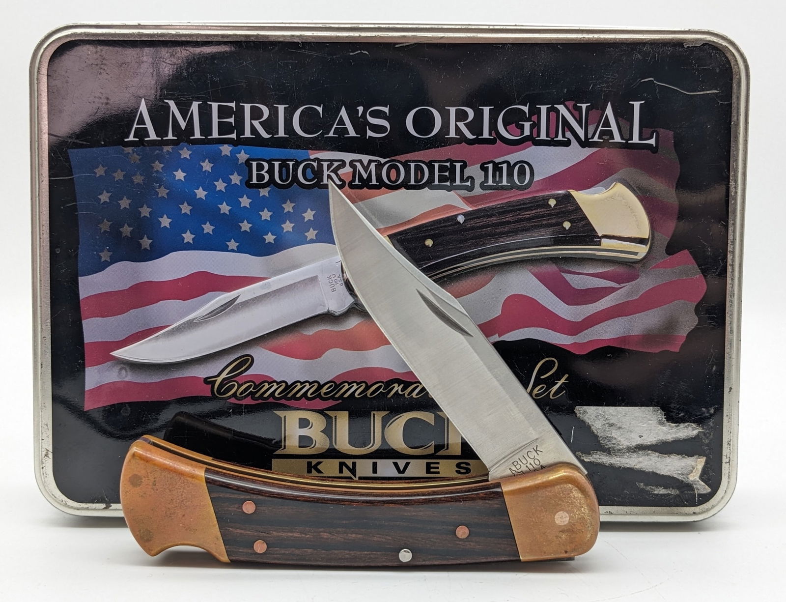 Buck 110 America's Original Tin Set: Comes with a buck bottle opener keychain. Knife is in like new condition with heavy tarnishing on the brass that can easily be polished. Overall measures 4-7/8in when closed.
