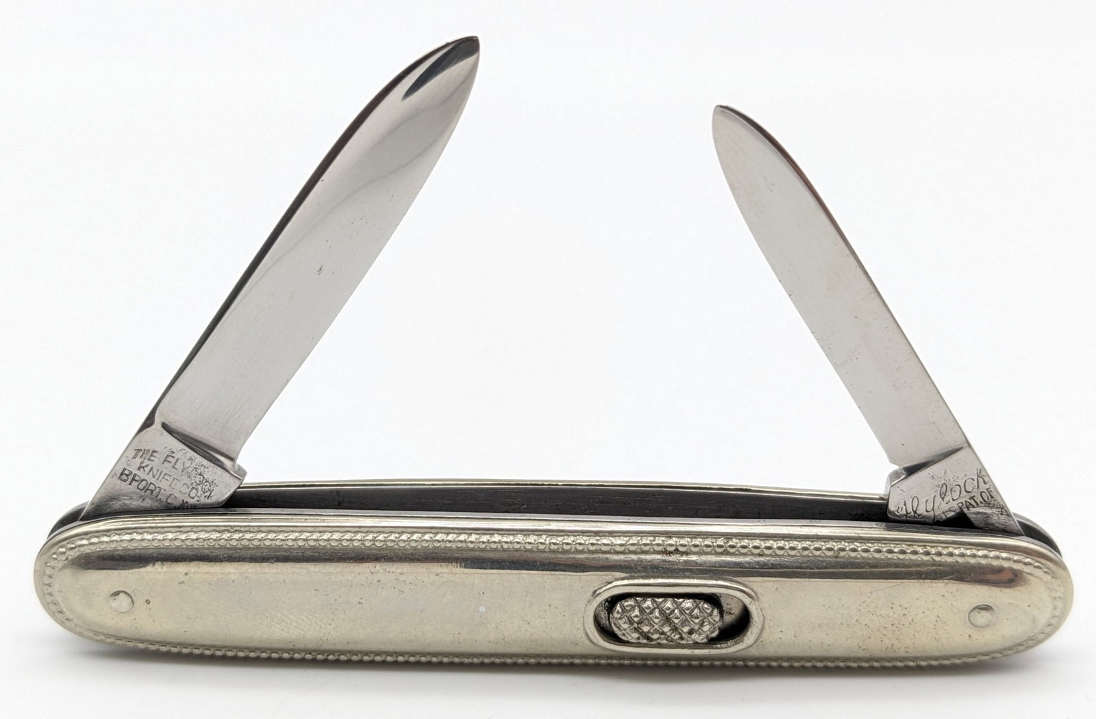 Flylock Metal Handle Double Switchblade Knife: Knife is in good condition with polished blades, and scuffs on the handle from use and handling. Knife springs are strong, and both have a little bit of play when open. Overall measures 3-1/2in when c