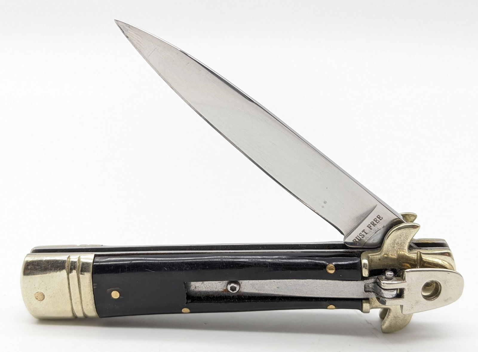 Unbranded Black Plastic Leverlock Switchblade Knife: Knife is in good condition with scuffs on the blade and bolsters with some tarnishing from handling. Knife spring is strong, and locks tight when open. Overall measures 4-1/2in when closed.