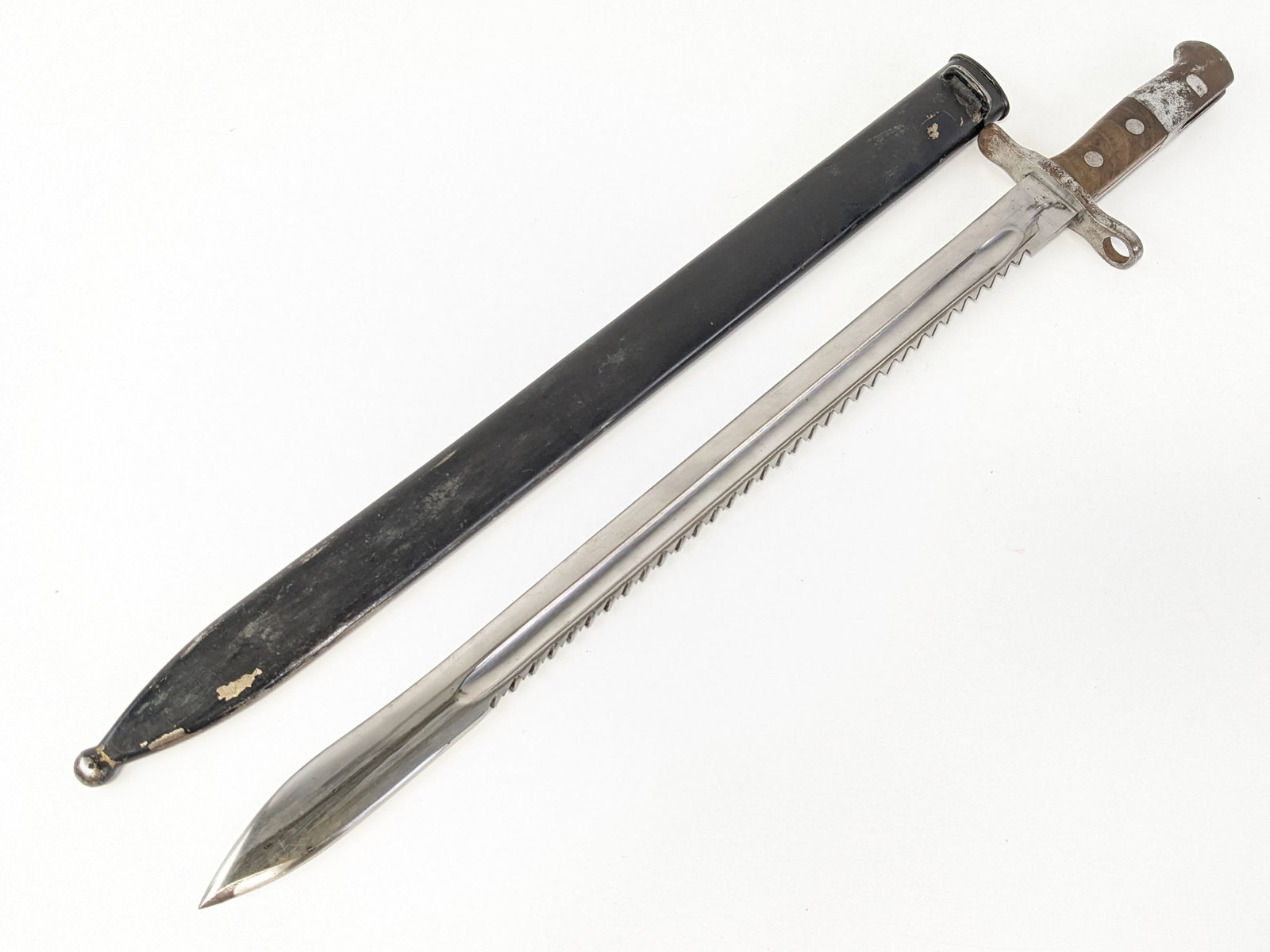 Swiss Model 1914 HS Pioneer Sawtooth Back Bayonet w/ Scabbard: Features a sawtooth spine blade stamped HS with an inspection mark on the tang, squared off steel guard, wood handle scales, and steel pommel. Bayonet is in nice condition with scuffs and tarnishing o