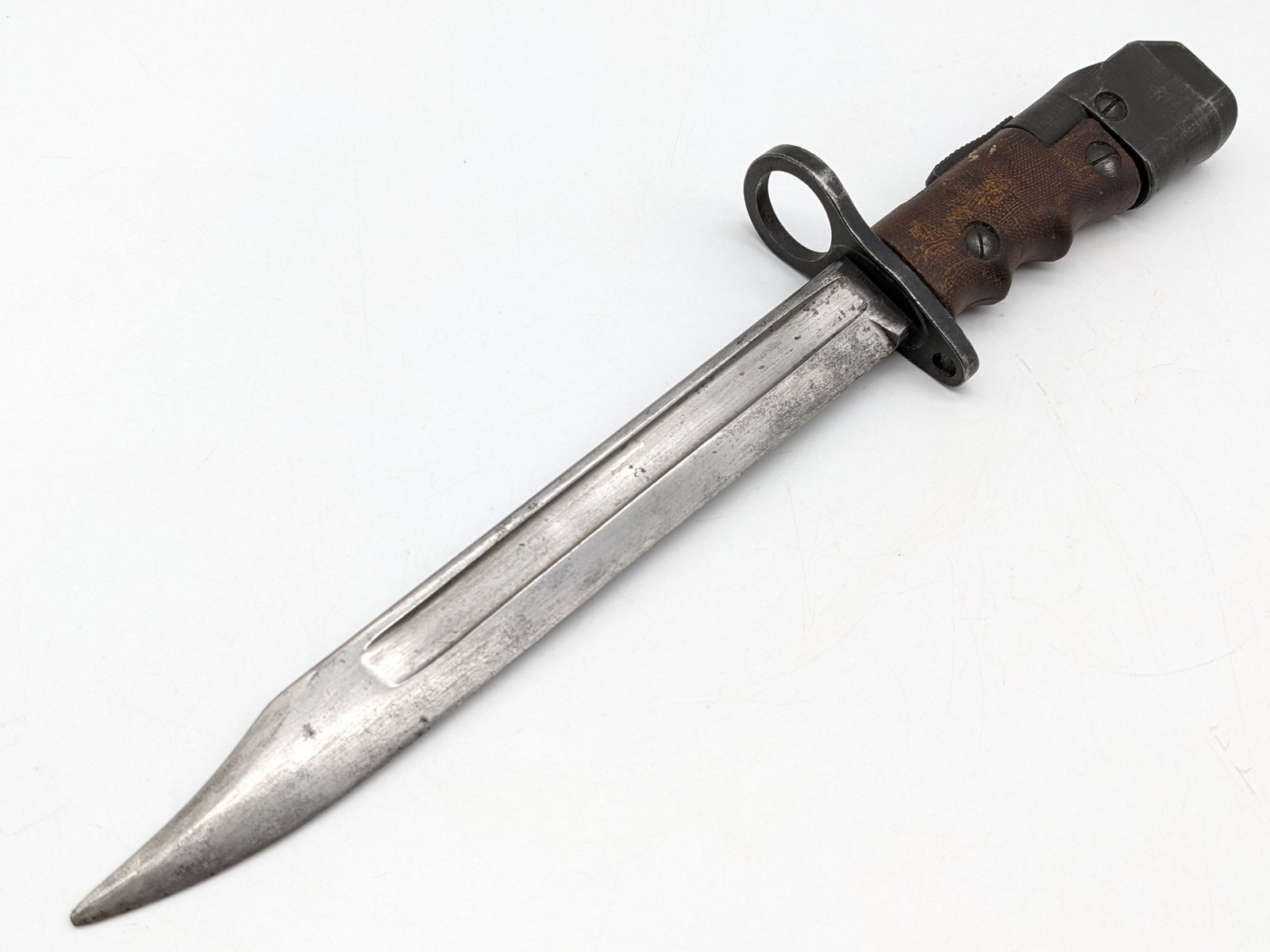 British Enfield No. 7 Mk 1 Fighting Knife Bayonet: A unique bayonet with the ability to rotate the locking lug into a fighting knife. Bayonet is in nice condition with scratches and tarnishing on the blade, scuffs on the handle, and general finish wea