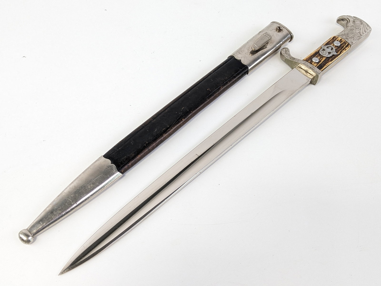 WWII German Police Dress Bayonet w/ Matching Scabbard: Knife is manufactured by Ewald Cleff in Solingen, Germany and features nickel plated drop point blade, nickel plated oak leaf pattern guard, stag handle scales with German police eagle, and nickel pla
