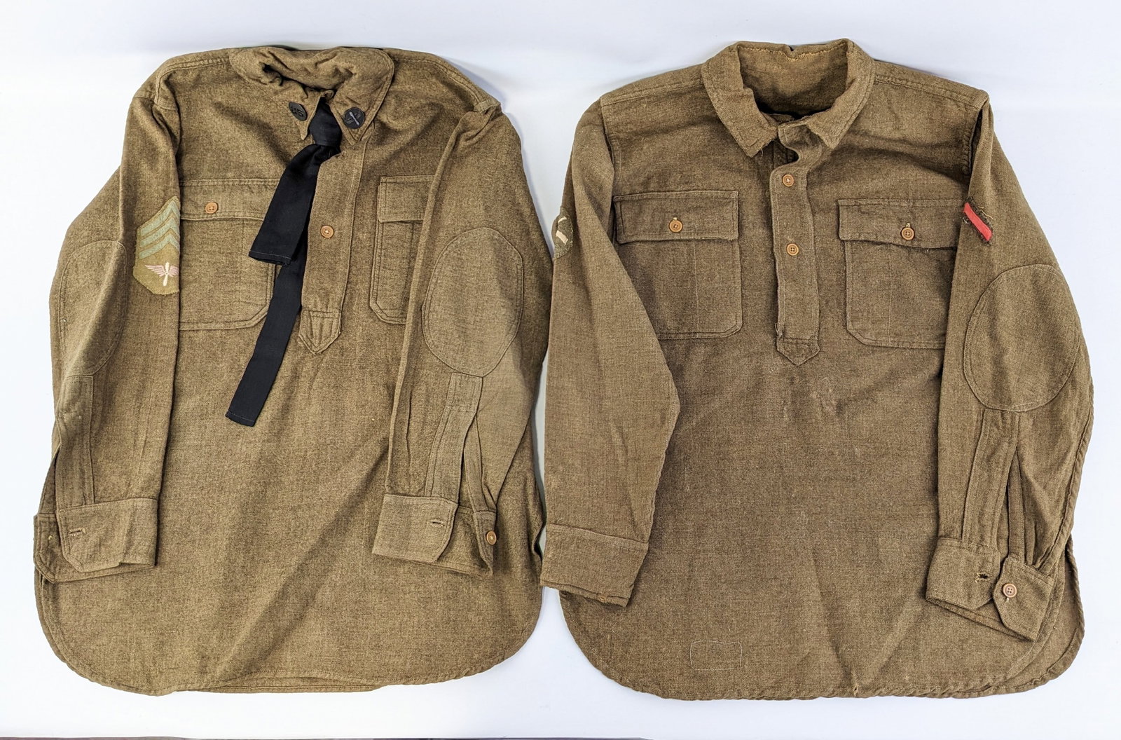 (2) WWI US Army Wool Field Shirts: The one shirt features US Army Air Corps collar coins and US Army Air Corps Sergeant shoulder patch, and the other shirt is bare. Both shirts are in very nice condition with general wear from use and 
