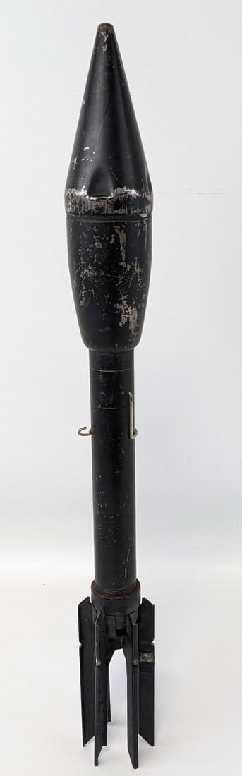 WWII US Bazooka Dummy Practice Rocket: The rocket head is able to unscrew with a solid rod inside that would normally be the fuse. Rocket is in nice aged condition with finish wear and dings from age and handling. Measures 21-3/4in long.