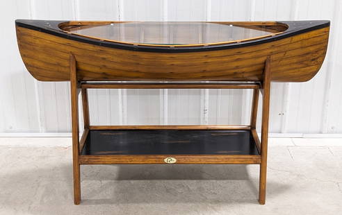 Ducks Unlimited Glass Top Canoe Console Table: Features a removable glass top with a hollow body canoe perfect to decorate with hunting / fishing related items. The canoe is removeable from the base for easy transportation. Measures 53in wide x 17