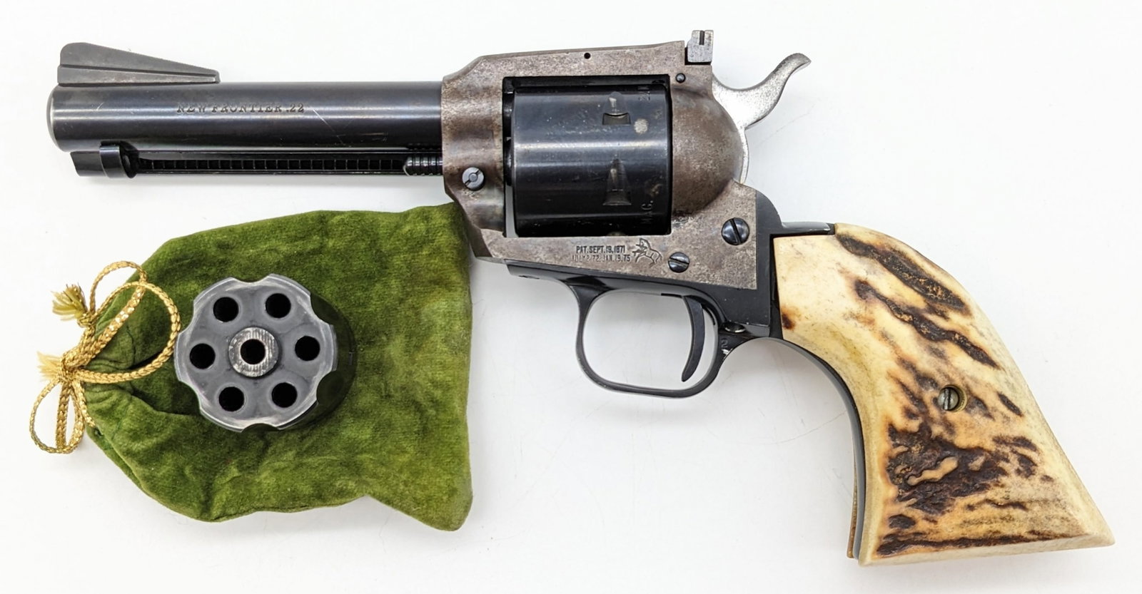 Colt New Frontier .22 Cal Single Action Revolver: Manufacturer: Colt.Model: New Frontier.Type: Revolver. Caliber/Gauge: .22 LR / .22 WMR. Barrel: 4-1/2 inch. Choke: . Finish: Color Case Hardened. Grip: Stag. Stock: . Condition: Used with expected scu