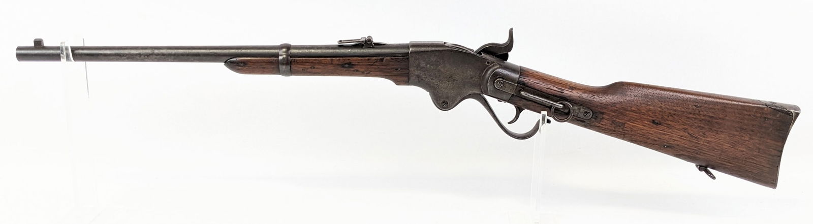 Spencer M1865 .56-56 Spencer Rimfire Saddle Ring Carbine: Manufacturer: Spencer Repeating Rifle Co..Model: M1865.Type: Rifle. Caliber/Gauge: .56-56 Spencer Rimfire. Barrel: 20 inch. Choke: . Finish: Worn Blued. Grip: . Stock: Wood. Condition: Aged with heavy