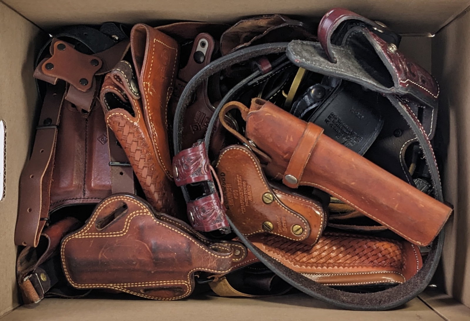 Various Style Leather Pistol & Revolver Holsters: Includes shoulder holsters, mag carriers, some belts, paddle holsters, and more. Holsters are in various used condition with some with heavier wear than others.