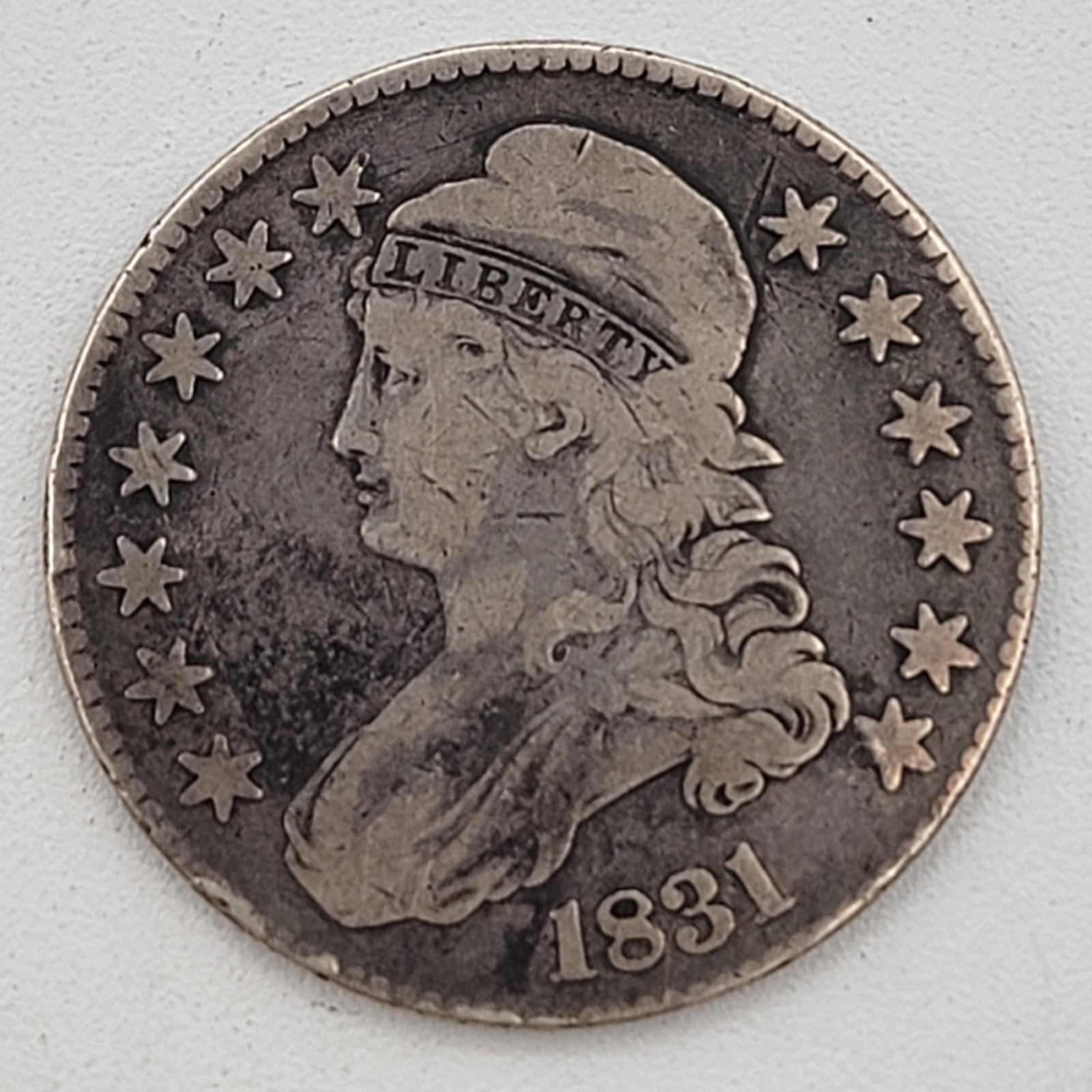 U.S. 1831 Capped Bust Silver Half Dollar: Circulated condition with some edge dings.