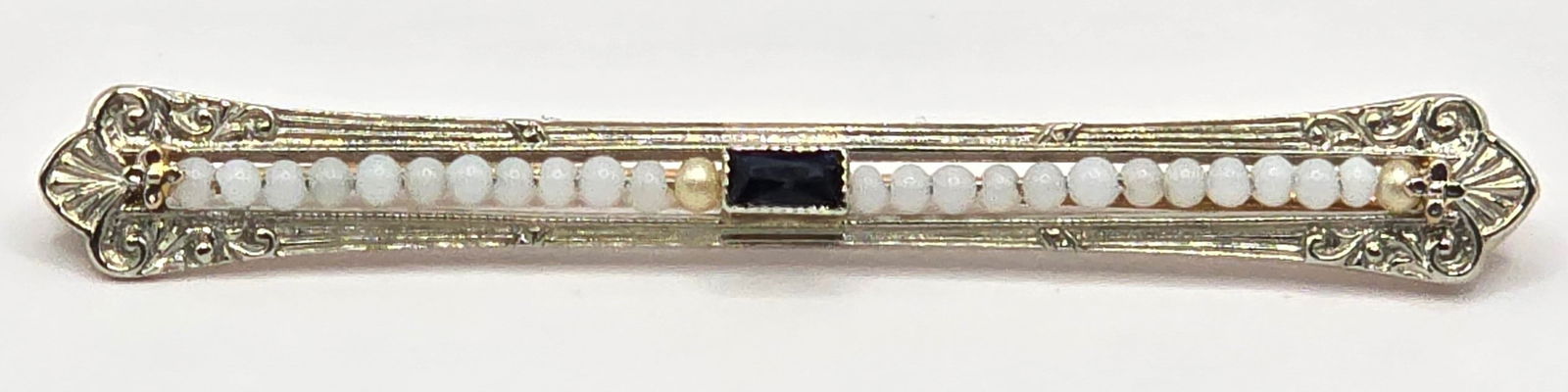 Antique 10K White & Yellow Gold Art Deco Seed Pearl & Sapphire Filigree Bar Pin: Antique 10K White & Yellow Gold Art Deco Seed Pearl & Sapphire Filigree Bar Pin. Beautiful pin in great condition. Measures 2-1/8" across x 1/4" wide. Total weight 2.79 grams.