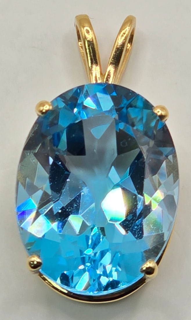 14K Yellow Gold Blue Topaz Pendant: 14K Yellow Gold Blue Topaz Pendant. Overall the pendant measures 1-1/4" tall x 1/2" wide and the total weight is 6.76 grams.