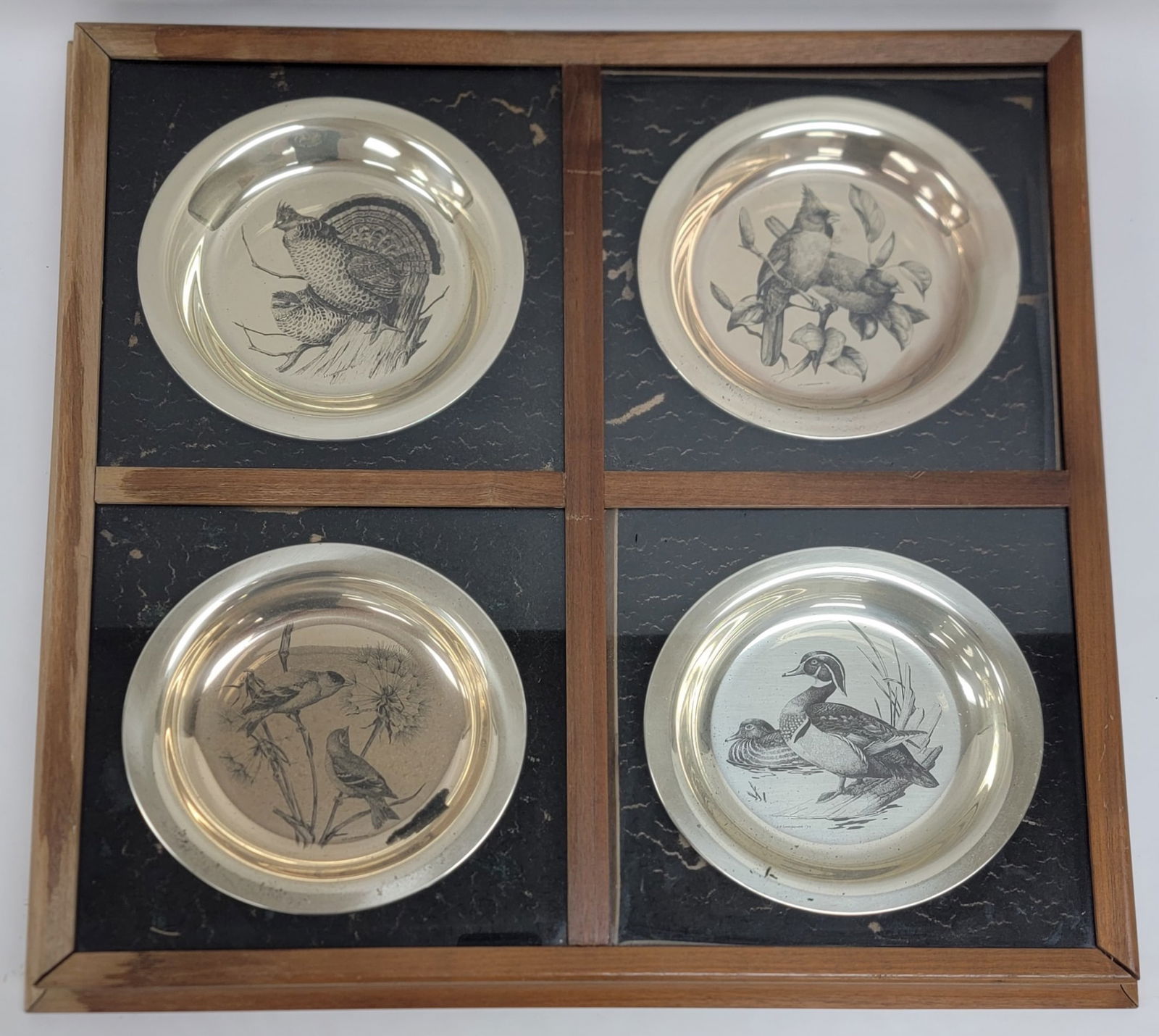 4 Pc. Franklin Mint Framed National Audubon Society Sterling Silver Etched Bird Plates: Framed set of four 1973 Franklin Mint National Audubon Society Solid Sterling Silver Etched Bird Plates. The plates include The Goldfinch, The Wood Duck, The Ruffled Grouse, and The Cardinal. The plat