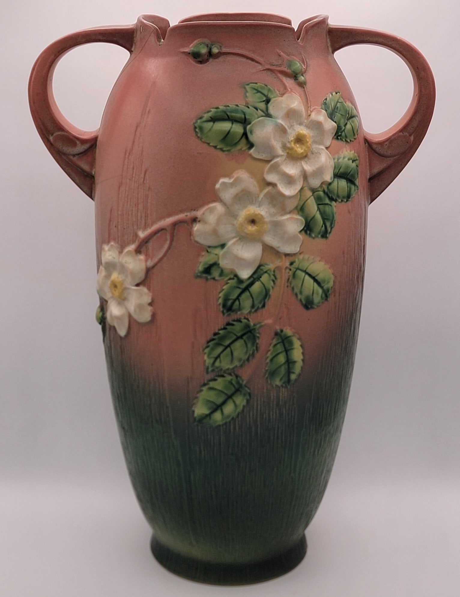 Roseville Pottery "White Rose" 18-1/2" Floor Vase "AS IS": Roseville Pottery floor vase in the "White Rose" pattern. The vase is # 994-18". The vase displays well, but has some heavy hairlines with some chips on one handle, the upper rim, and the base. Measur