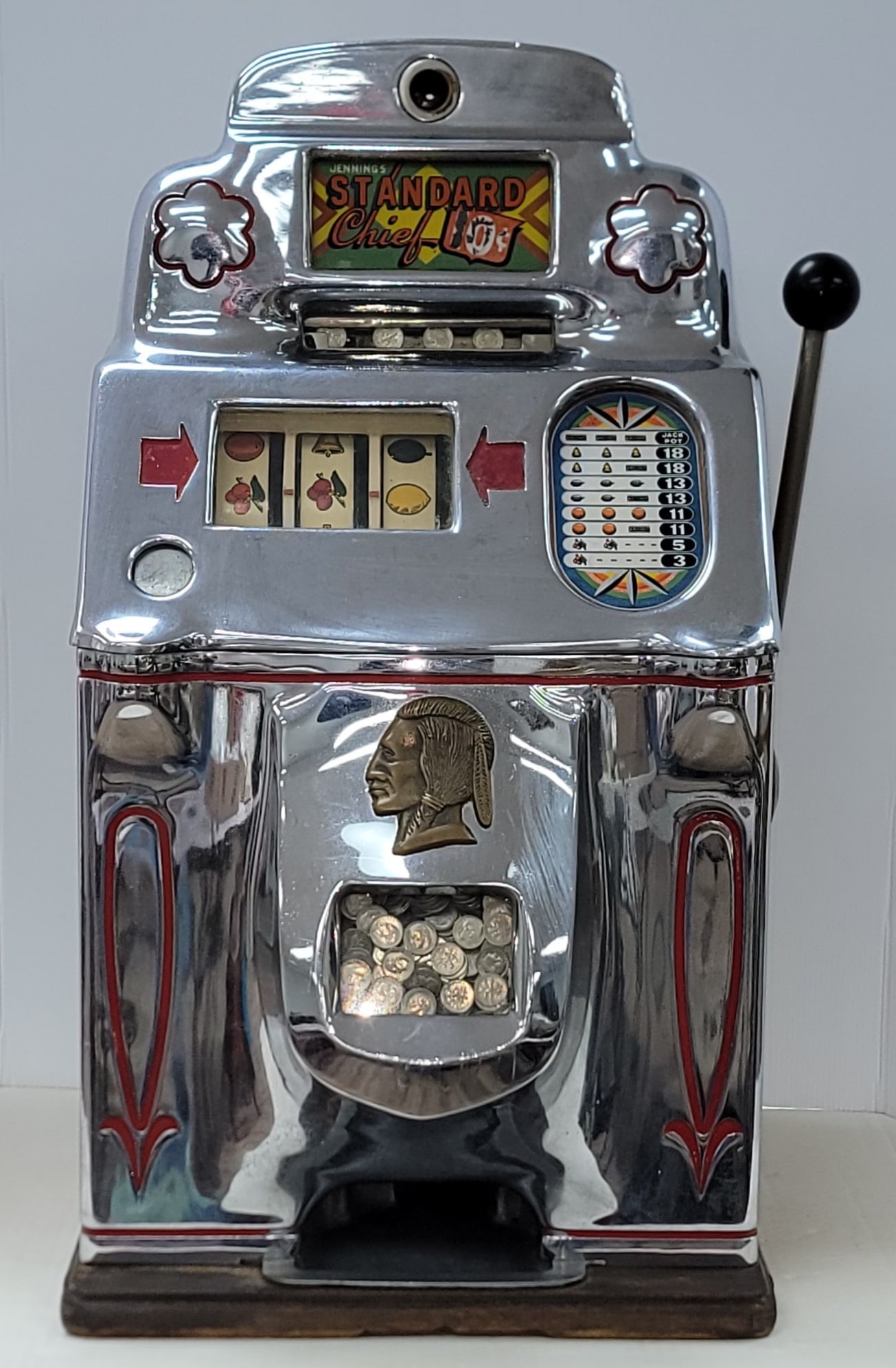 Vintage Jennings Standard Chief 10 Cent Slot Machine: Vintage Jennings Standard Chief 10 Cent Slot Machine. The machine is in nice condition with some touch-ups, has some age and use wear. It is not working and is missing the key. Comes mounted on the or